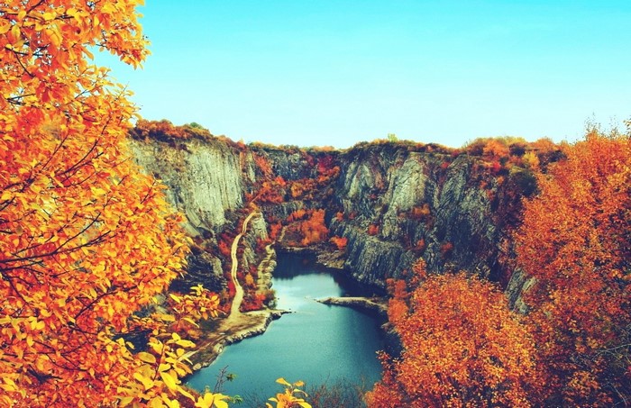 Autumn canyon with a lake and colorful trees