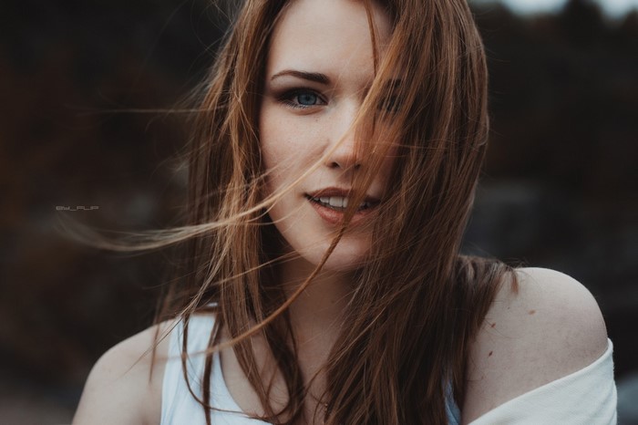 Woman with long brown hair and blue eyes