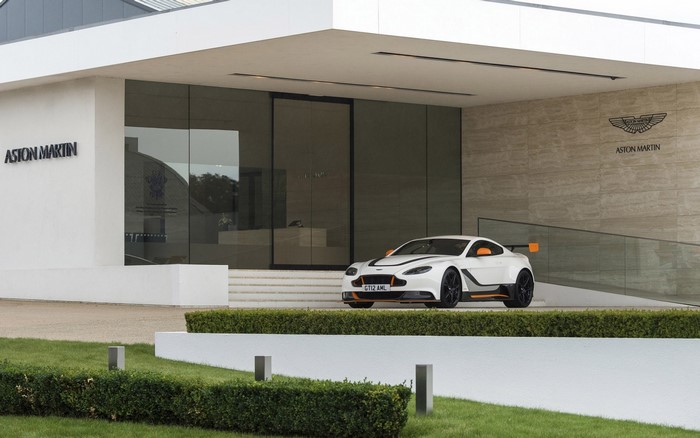 White Aston Martin GT12 Vantage in front of Aston Martin building