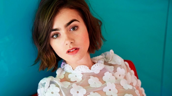 Lily Collins portrait with blue background