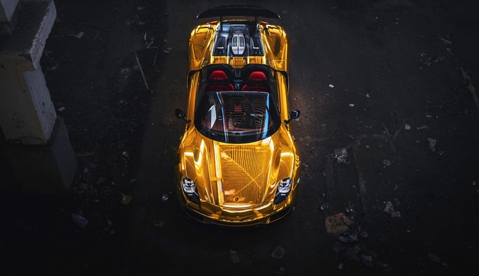 Golden Porsche 918 Spyder parked at night