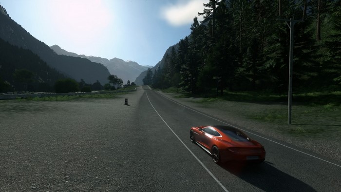 Orange sports car driving on a mountain road