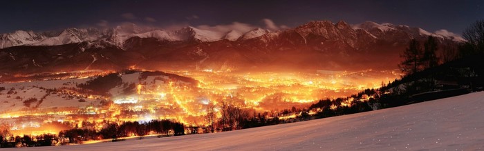 Glowing valley at night with snow-capped mountains in Poland