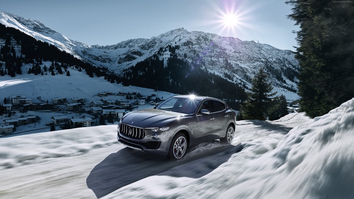 Maserati Levante driving on a snowy mountain road