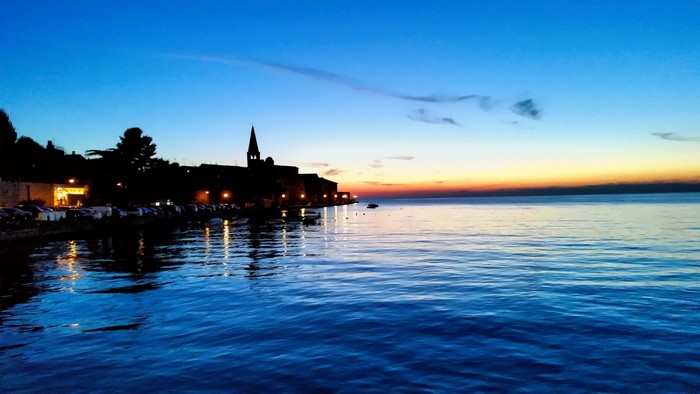 Coastal town at dusk with reflections on the water