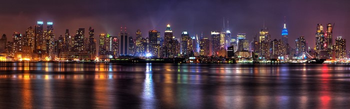 New York City skyline at night with reflections