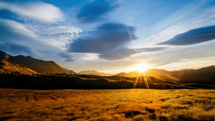 Sunset over mountains and meadows