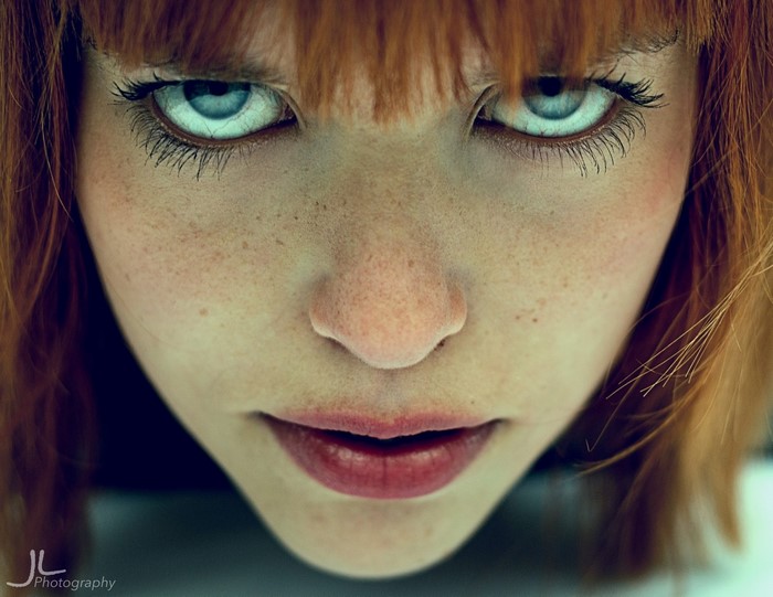 Close up portrait of a redhead woman with blue eyes