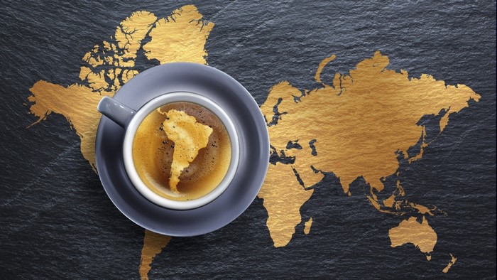 Coffee cup with South America map on world map