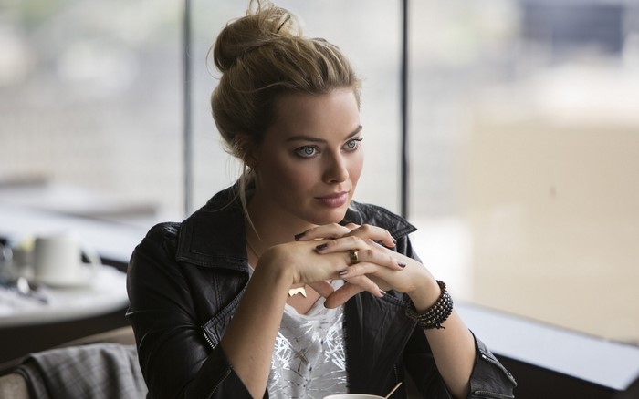 Margot Robbie with blonde hair in a bun