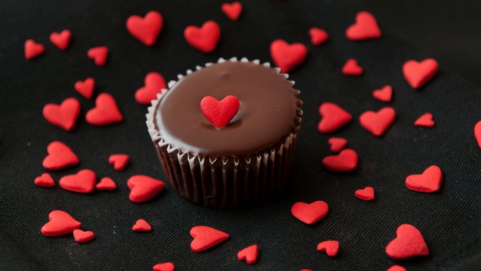 Chocolate cupcake with red heart sprinkles
