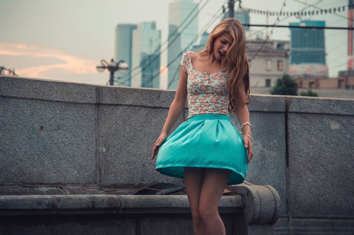 Woman in floral top and turquoise skirt