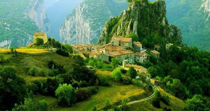 Village nestled in a green mountain valley