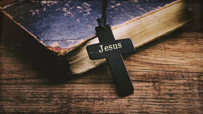Cross with Jesus inscription on a Bible