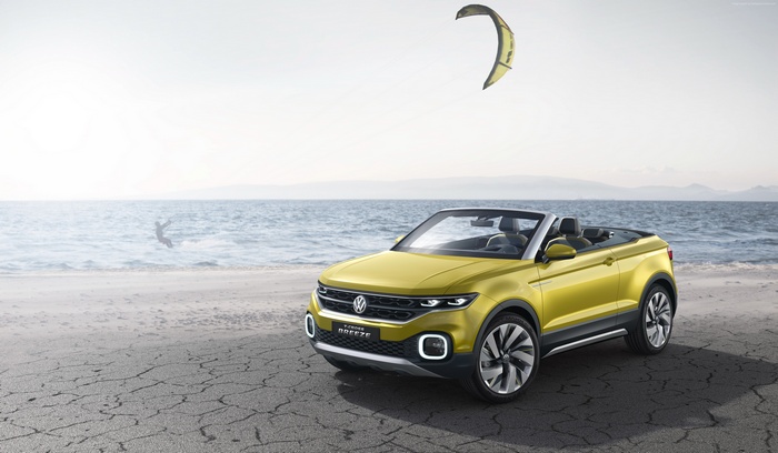 Yellow Volkswagen T-Cross Breeze convertible on a beach