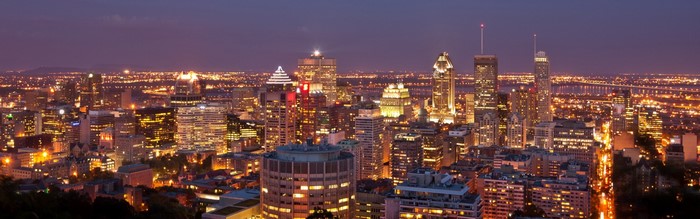 Montreal cityscape at dusk with illuminated skyscrapers