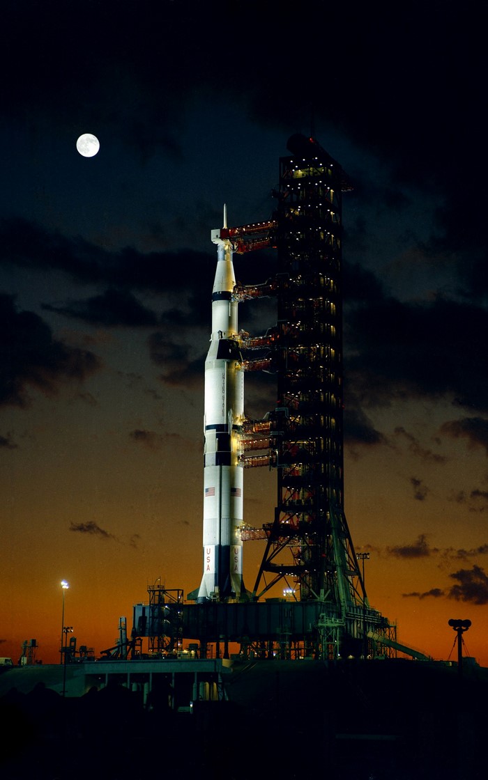 Saturn V Rocket on Launch Pad at Dusk with Moon