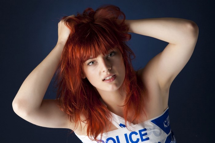 Woman with red hair and police tape