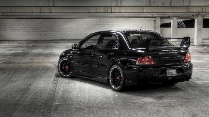 Black Mitsubishi Lancer Evolution parked in a garage