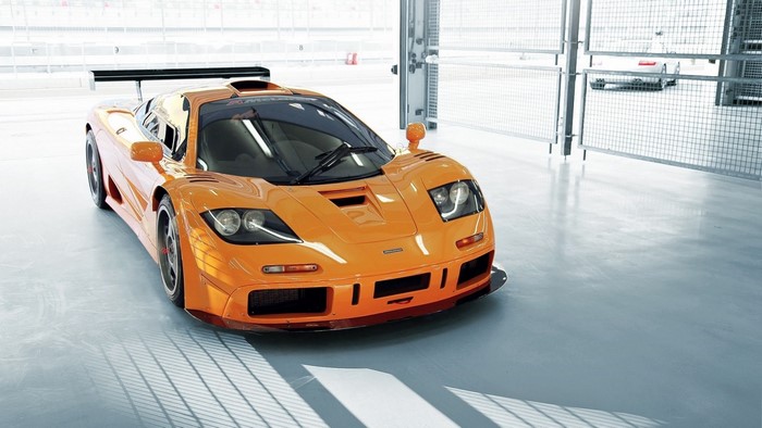 Orange McLaren F1 GTR race car in a garage