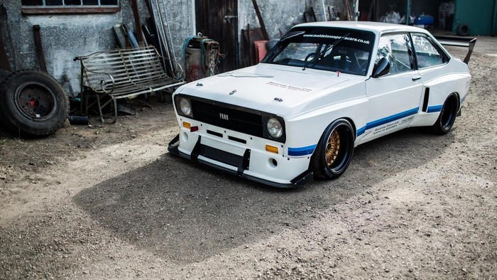 White Ford Escort Mk1 race car with blue stripes