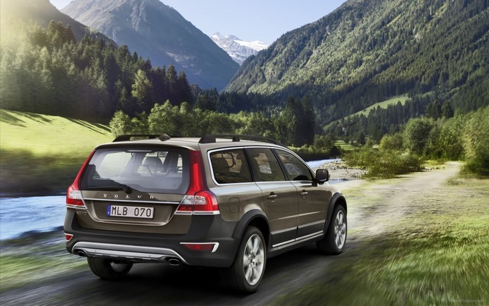 Volvo XC70 driving on a dirt road in the mountains