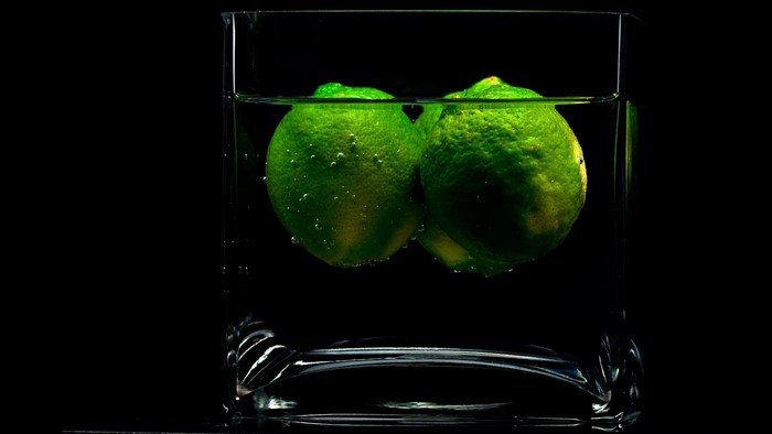 Two limes in a glass of water