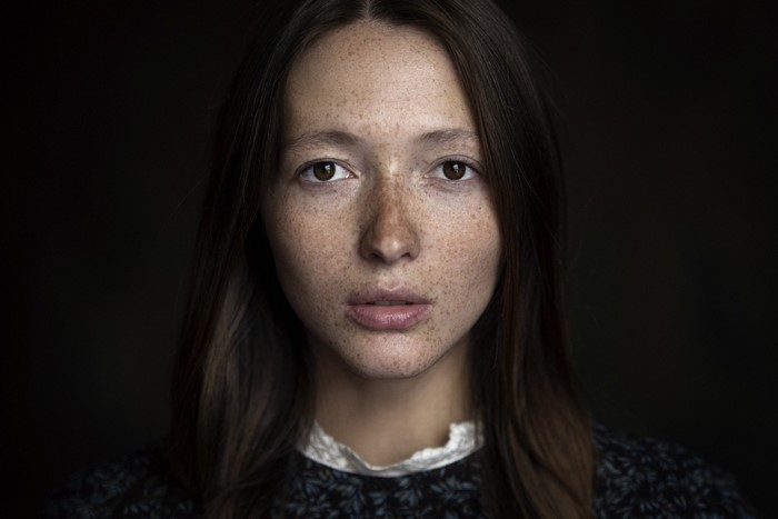 Close-up portrait of a woman with freckles