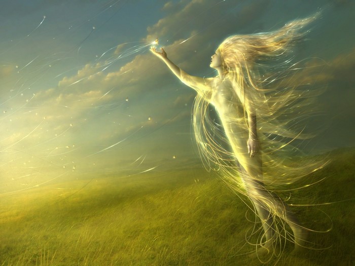 Fantasy woman with flowing hair in a grassy field