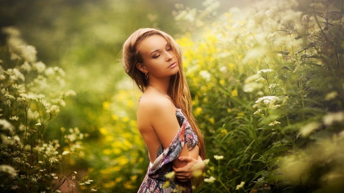 Woman in a floral dress in a meadow