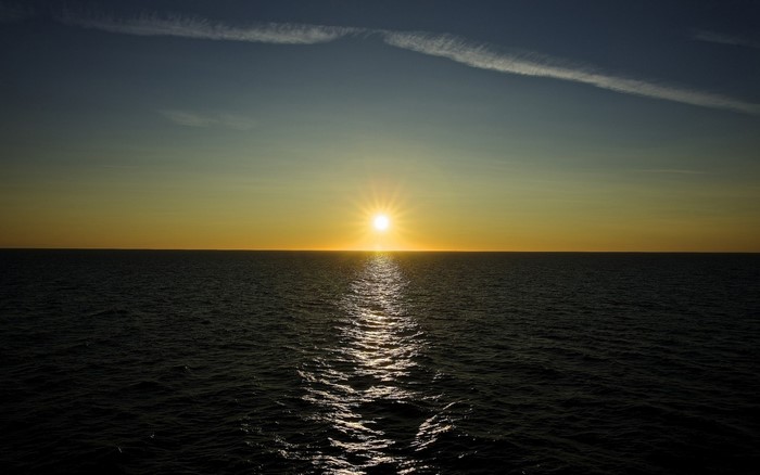 Sunset over the ocean with reflection