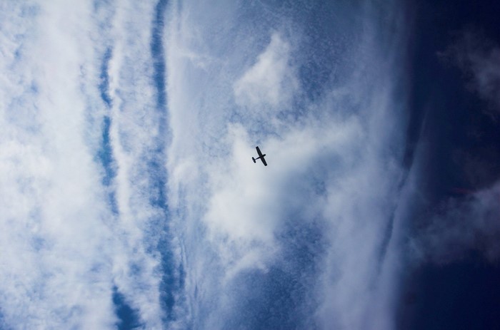 Airplane flying through clouds in the sky