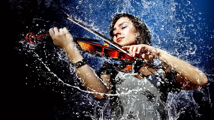 Woman playing violin in water splashes