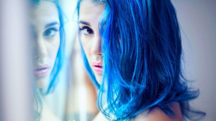 Woman with blue dyed hair looking at viewer