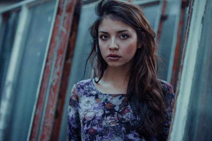 Woman with long brown hair wearing a floral dress