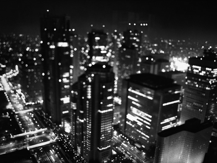 Monochrome cityscape at night with bokeh lights