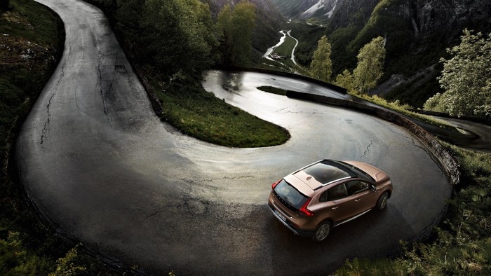 Volvo car driving on a winding mountain road