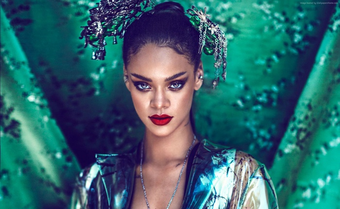 Rihanna with elaborate headpiece and metallic jacket