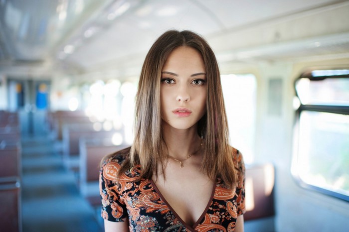 Portrait of a Woman with Long Brown Hair in a Train