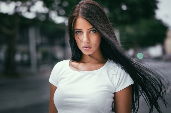 Portrait of Brunette Woman with Long Hair in White Top
