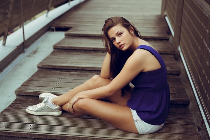 Woman sitting on wooden stairs
