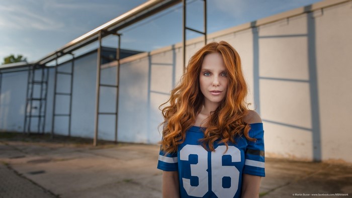 Redhead woman wearing a blue sports jersey with number 36