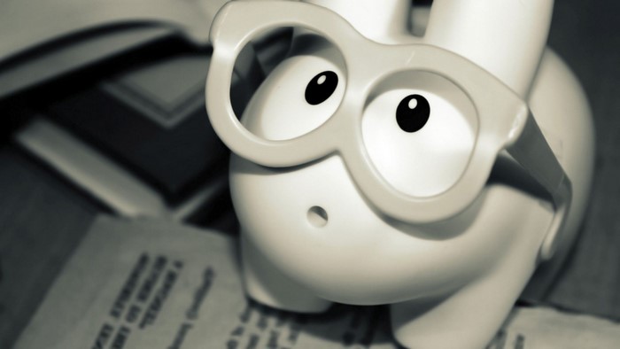 Close up of a white toy rabbit wearing glasses