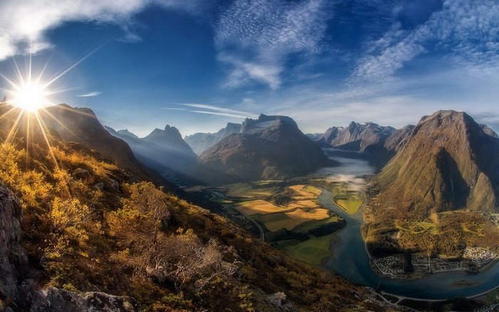 Sunlit Mountain Valley and River in Norway