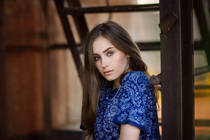 Young woman with long brown hair and blue eyes