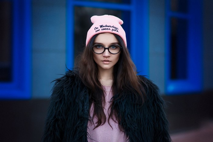 Woman wearing pink beanie and glasses