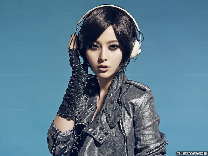 Woman with headphones and studded jacket