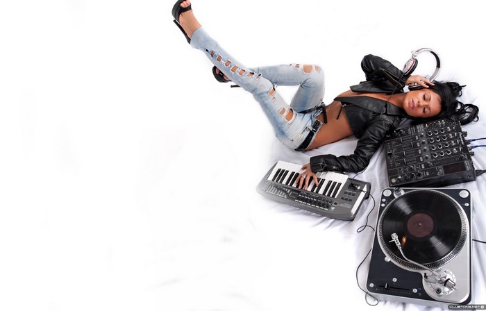 Woman DJ with headphones, keyboard, and turntable