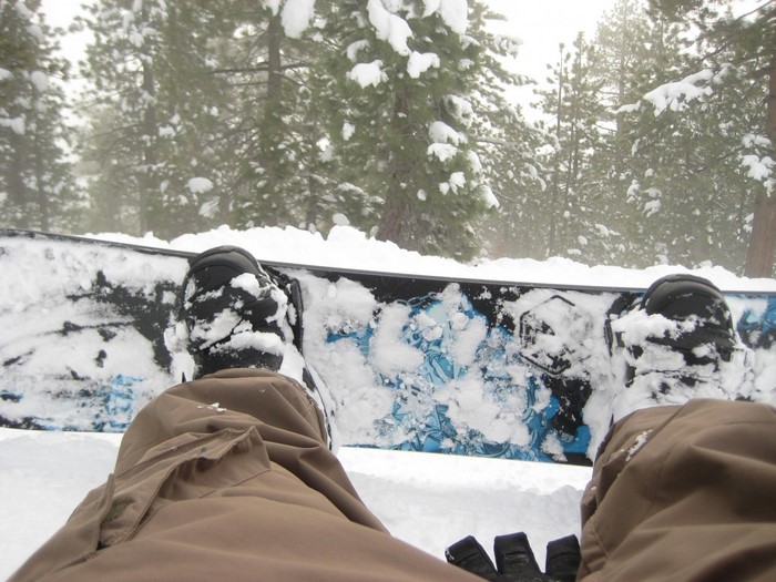 Snowboarder's view in a snowy forest