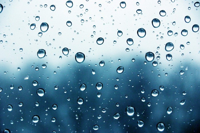 Raindrops on glass with blurred background